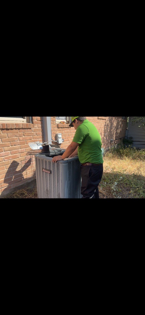 Technician performing routine HVAC maintenance