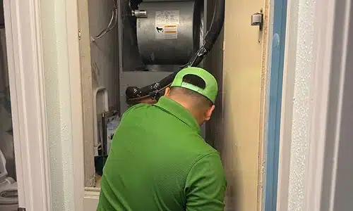 Smart Choice technician servicing an indoor air handler in a San Antonio home