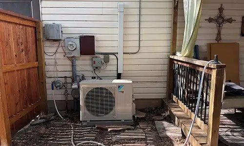 Outdoor air conditioning condenser unit beside a San Antonio home