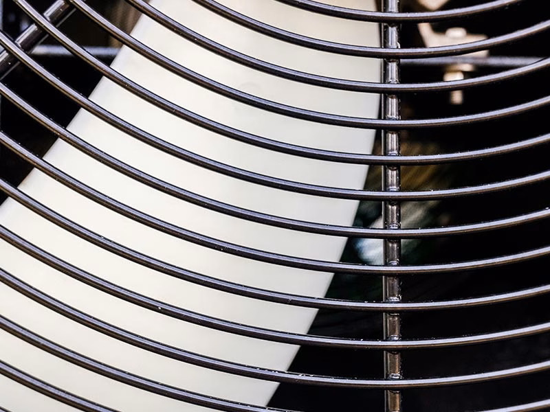 Close up of the aluminum condenser coil fins on a residential air conditioner