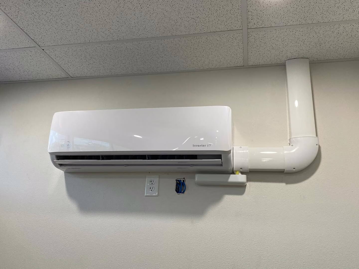 Newly installed ductless mini split indoor unit with line set cover in a San Antonio home