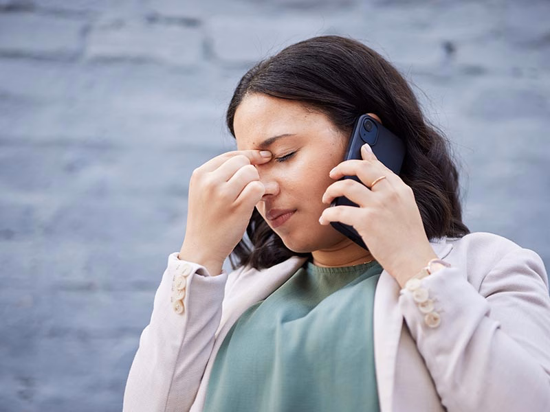 Homeowner on the phone calling for emergency air conditioning repair